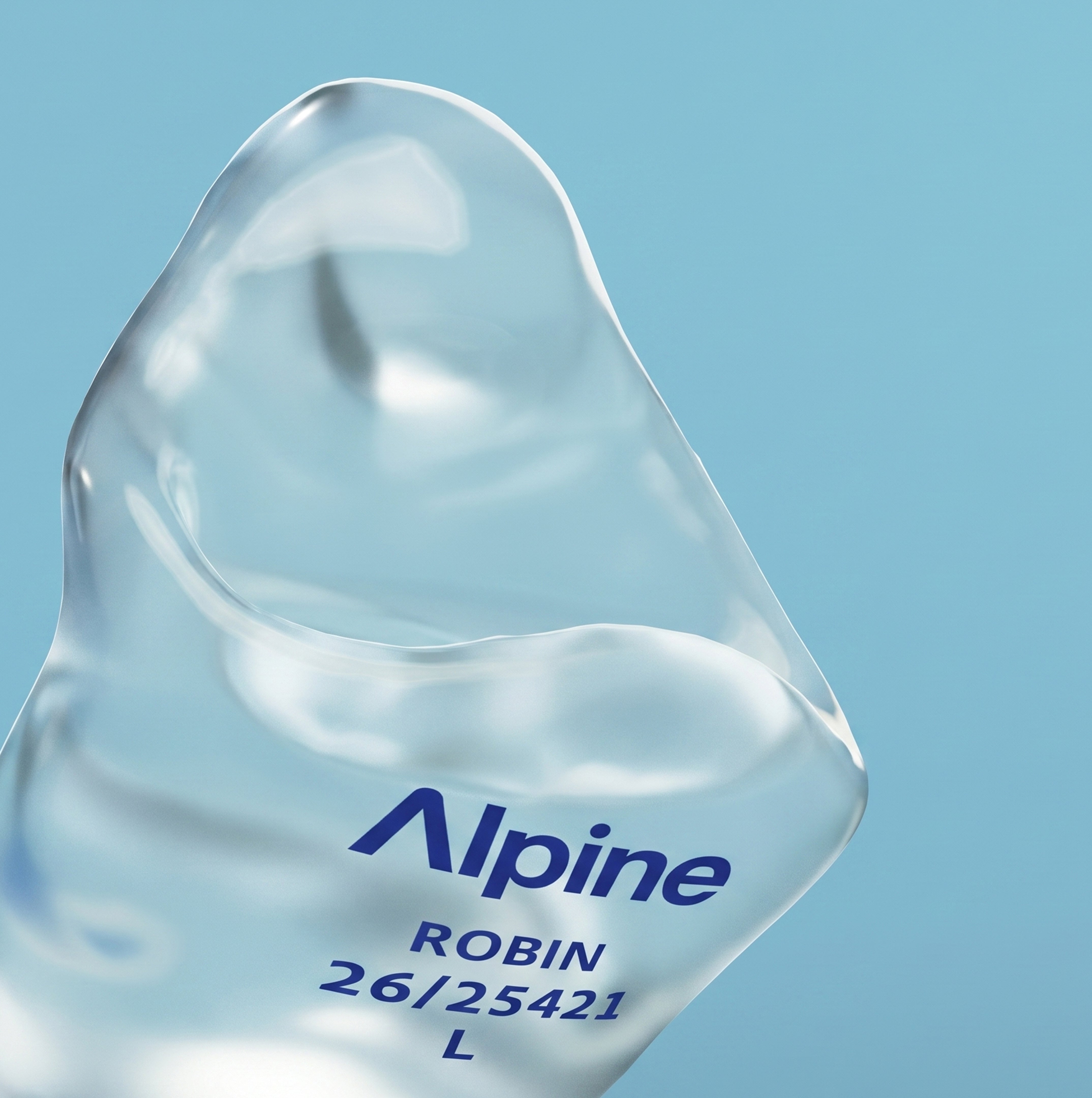 Close-up of an Alpine SleepSoft Custom Transparent earplug with the engraving &