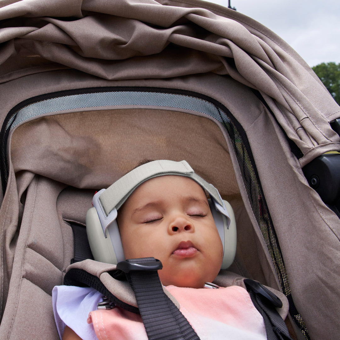 Baby sleeping while wearing muffy baby in soft-sand 