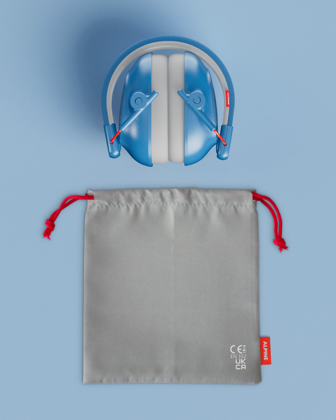 Alpine Muffy Baby ear defenders in blue, folded, with grey carrying pouch 
