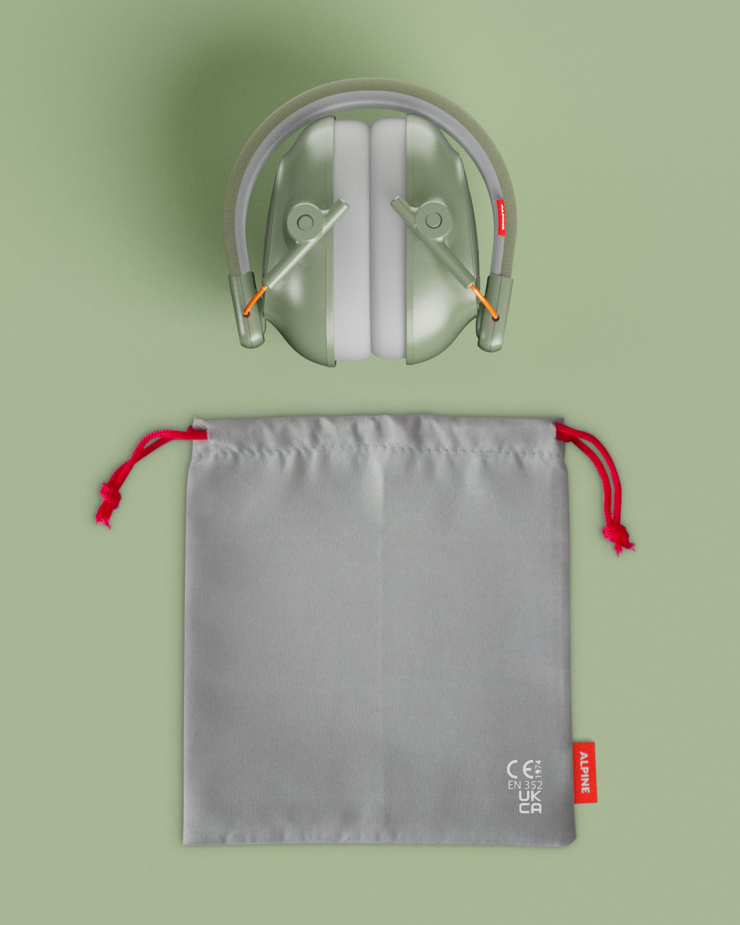 Alpine Muffy Baby ear defenders in green, folded, with grey carrying pouch 